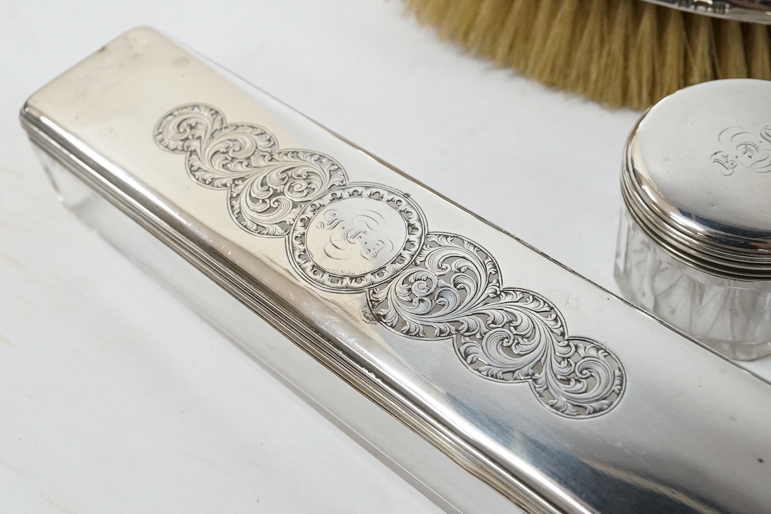 A 19th century Dutch white metal octagonal vinaigrette, with engraved geometric decoration, 51mm, together with two William IV silver mounted glass toilet jars, George Reid, London, 1834, one other later silver mounted g